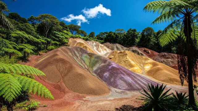 Scenic Landscape of Seven Colored Earths in Chamarel Mauritius Under Bright Blue Sky Surrounded by Lush Vegetation