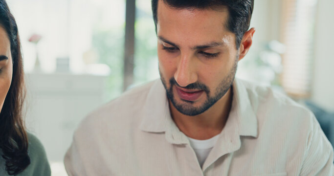 Close up young Latin couple male, female serious focus on laptop computer check document paper pay bills online plan budget expense in living room at home. Marriage money trouble, Family budget plan.