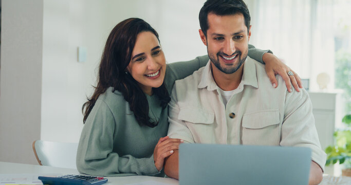 Young Latin couple male, female customers paying by credit card online and laptop shopping online furniture decorate home in living room at home. Young married moving home shopper online concept.