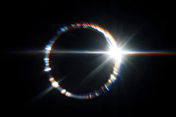A solar eclipse with a bright corona and colorful light flares. © Rawpixel.com