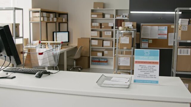 Modern post office reception desk standing empty with computer, barcode scanner and parcel shelves. Ideal for e-commerce delivery logistics and supply chain business concepts