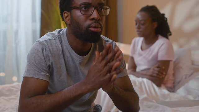 African American couple relationship crisis in bedroom divorce problems frustrated man embarrassed woman ignoring boyfriend family conflict separation health problem infertility evening home indoors