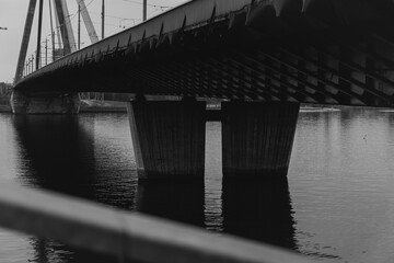 A striking perspective of a cable-stayed bridge over a calm river, showcasing urban infrastructure and architectural design © Христя Сидор