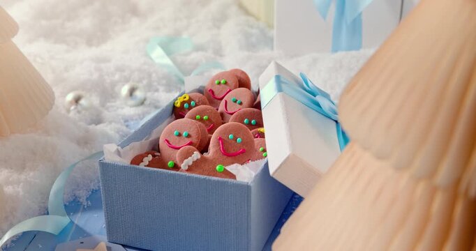 Cute Christmas gingerbread men fill light blue present boxes.