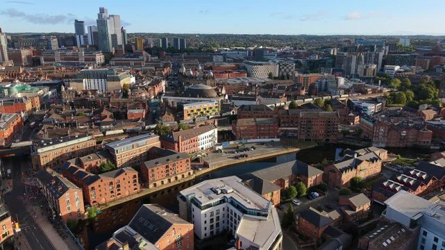 Aerial Video of River Aire Waterfront, The Calls, and a train travelling across Leeds Cityscape at Sunrise