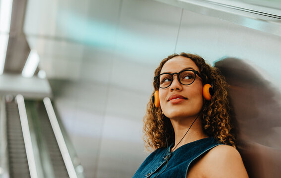 Commuting through an urban transit station while listening to music