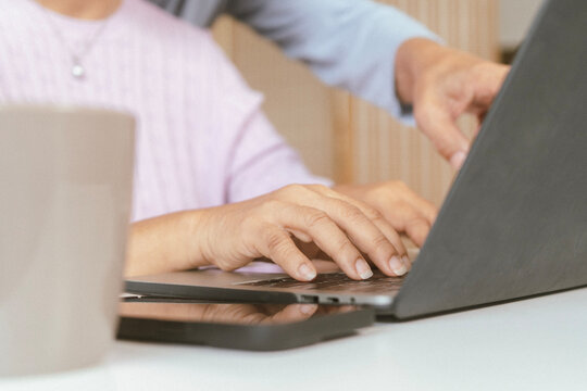 senior couple and documents with laptop for finance, budget planning or retirement annuity on sofa. Elderly man, woman or house with smile, computer or paperwork for pension fund or insurance
