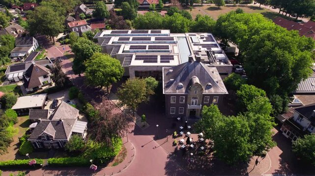 Aerial reveal of Dutch town Gorssel, The Netherlands, with MORE museum in the village art center seen from above
