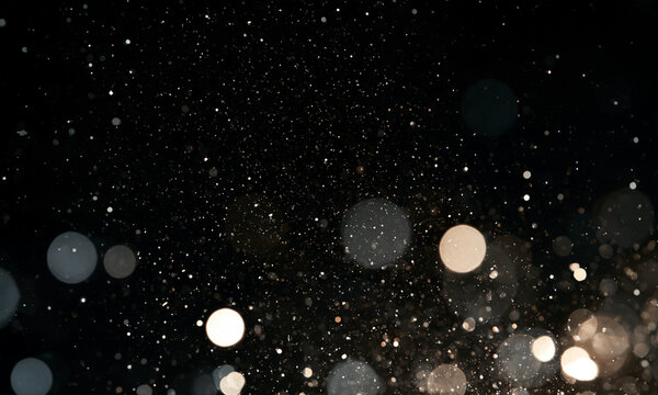 Light particles scatter softly against a dark background. Circular bokeh creates a warm and cool-toned layered effect. This image is ideal for atmospheric and ambient visual themes.