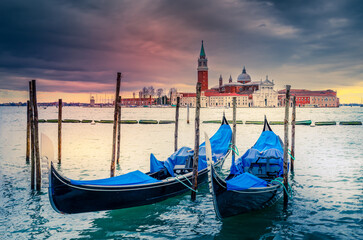 Venice Italy. Gondolas moored by Piazza San Marco, sunset colors. © ecstk22