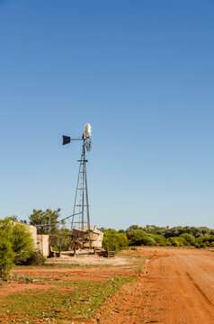 Traditional Metal Windmill Along a Red Dirt Road in the Australian Outback near Kalgoorlie, Western Australia, Australia