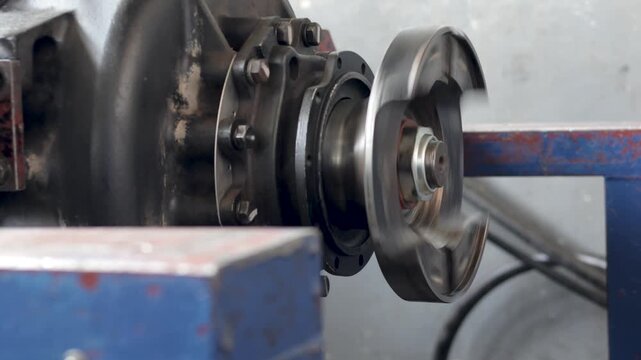 A rotating drive output flange with a threaded nut tested indoors.