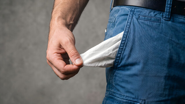 Man showing empty pockets demonstrating bankruptcy, financial crisis, and lack of money