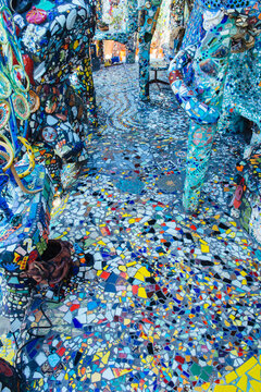 Colorful mosaic sculpture with decorative tiled walkway