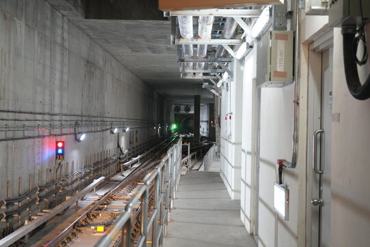 An underground subway train tunnel with railway tracks.