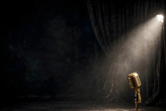 Vintage microphone on stage with spotlight and dark background, empty performance setting ideal for music, talent, entertainment, and event concepts