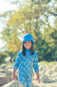 Carefree Little Girl Playing with Beach Toys on a Sunny Beach