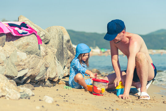 Father and Daughter Enjoying Quality Time Playing Together on the Beach