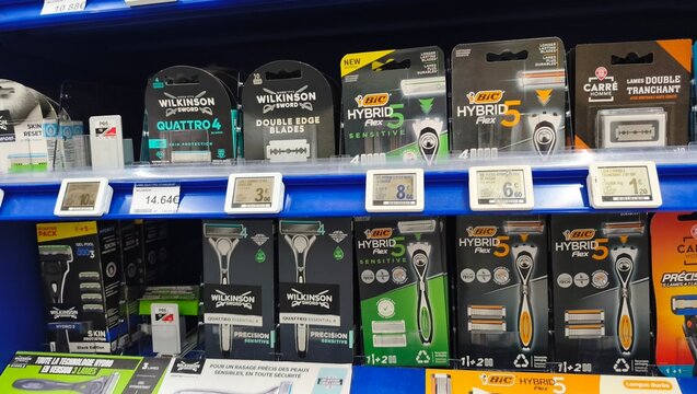 Royan, France - July 25, 2026: E.Leclerc ROYAN CEDEX. Display of various razor products including Wilkinson and BIC brands on a retail shelf in a supermarket setting