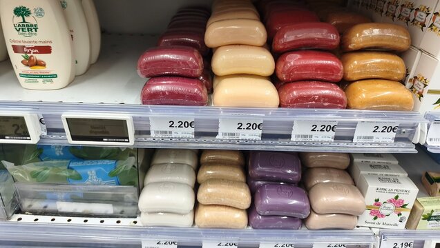 Royan, France - July 25, 2026: E.Leclerc ROYAN CEDEX. Assorted colorful soap bars displayed on a retail shelf with price tags and skincare products in the background