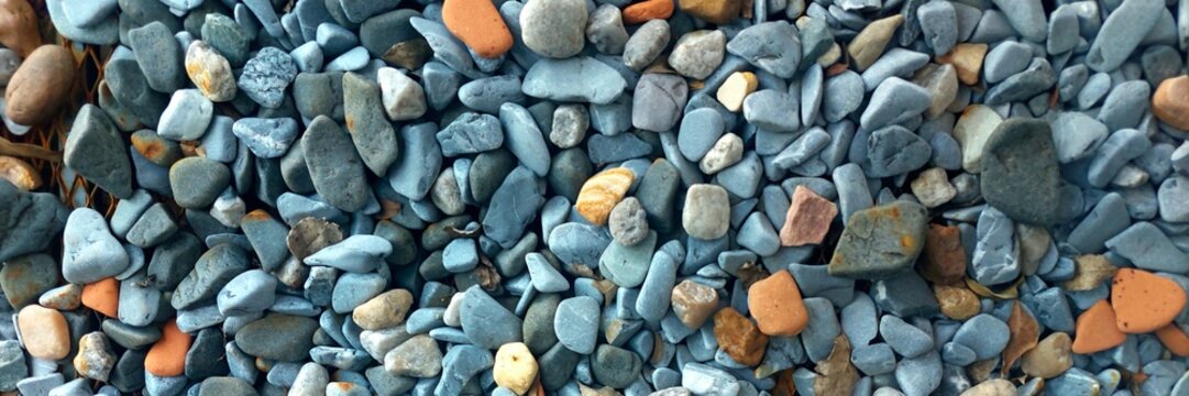 Natural gray and orange gravel creating a textured background pattern