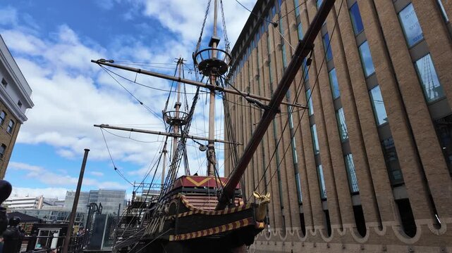 Dynamic tracking shot circling replica galleon ship in London city street