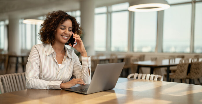 Web banner of african business woman talking on mobile phone in coworking office workspace, having client call. In 30s, female banker works as broker, accountant, employee, staff. Copy space