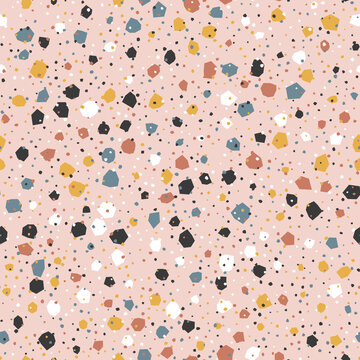 Seamless terrazzo pattern with stone chips on blush pink