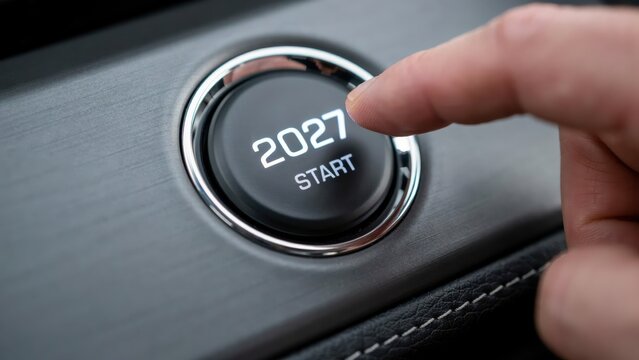 A person pushing a start button labeled with the year 2027 in a modern car dashboard. Ideal conceptual image for new year transitions and automotive future technology themes.
