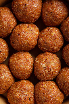 Close-up view of traditional Kazakh dairy sweet irimshik shaped into neat balls, isolated on white background