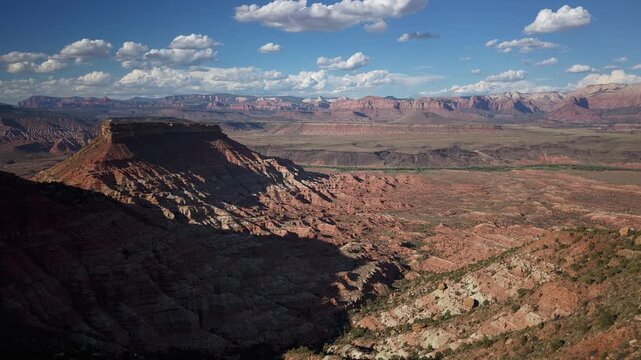 Aerial hyperlapse imagery showcases Zion National Park from Gooseberry Mesa in Utah with dramatic cloud movements and blue skies.