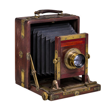 Vintage antique wooden folding bellows box camera with brass lens isolated on white background