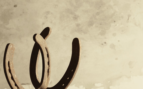 Rusty iron horseshoes against a weathered background