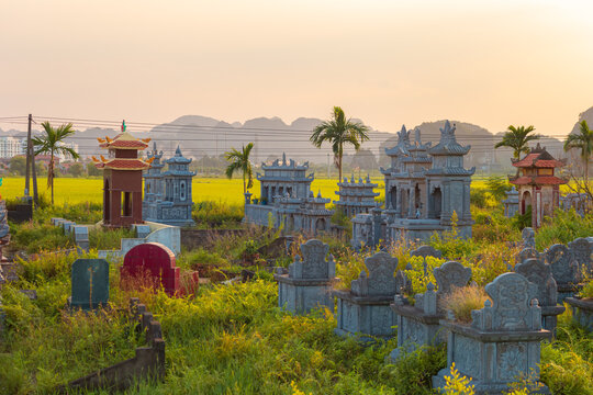 A traditional Vietnamese cemetery at sunset. Ninh Binh Province, Vietnam.