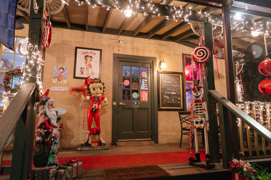 St. Augustine,FL,USA - Dec.30.2024: A vintage Betty Boop statue and skeleton nutcracker decorate a shop porch in St. Augustine, Florida. Christmas lights, candy canes, lollipops, Santa figures, and