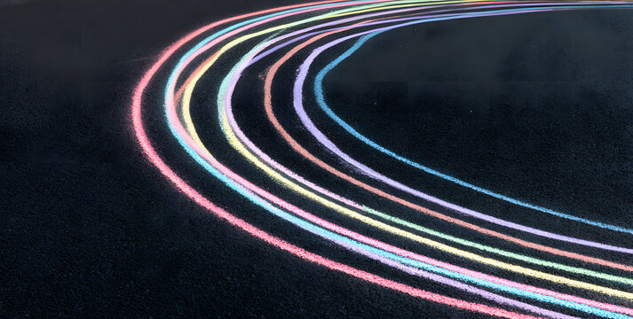 Bursting, chalky lines dance across a matte asphalt, forming an abstract pattern with pastel tones. This playful design serves as a vibrant backdrop for imaginative projects and artistic endeavors.