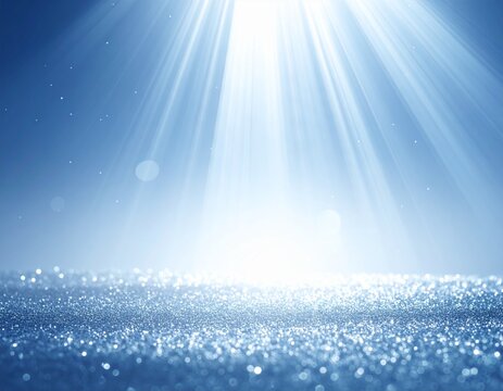 素材　光　Sparkling blue glitter surface background with bright white light rays shining from above and soft bokeh

