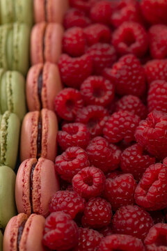 macaroons of different colors with raspberries