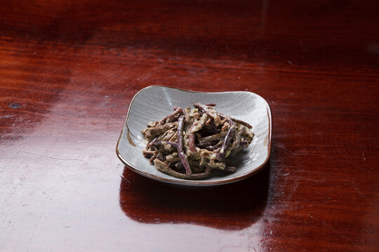 Korean seasoned fernbrake namul side dish on small ceramic plate