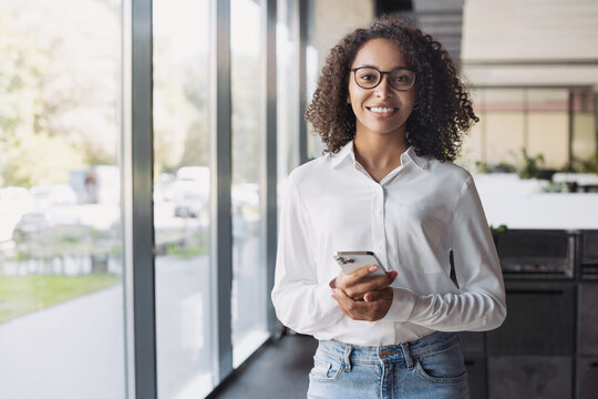 Business woman with smartphone in modern office, Smiling student girl holding mobile phone indoors, technology and business people lifestyle concept