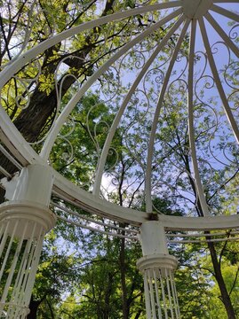 White metal openwork gazebo in a public park