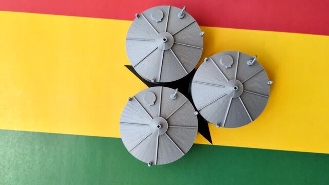 Liquefied gas storage tanks set against the Ghana flag. Liquefied gas tanks
