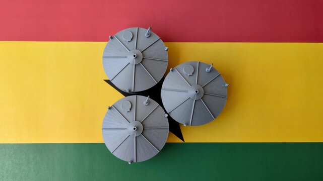 Liquefied gas storage tanks set against the Ghana flag. Liquefied gas tanks