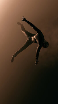 Minimalist lone person stretching from low angle with moody low key lighting