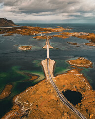Vertical aerial view of long coastal road and bridges connecting rocky islands in fjord in Lofoten Norway © Quality by Simon