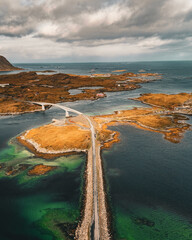 Vertical drone aerial view of coastal road and bridges connecting rocky islands in fjord landscape in Lofoten Norway © Quality by Simon