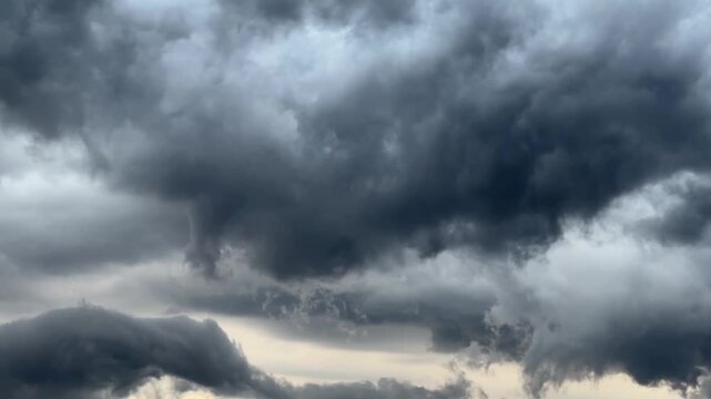 Dramatic Dark Storm Clouds Moving Across Sky Time Lapse, Cumulus Thundercloud Sky Background. Time-lapse footage of heavy dark storm clouds gathering and moving across the sky. Dramatic atmospheric ba