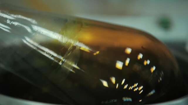 Macro close up shot of rotary evaporator flask rotating in warm water bath for chemical solvent distillation in laboratory