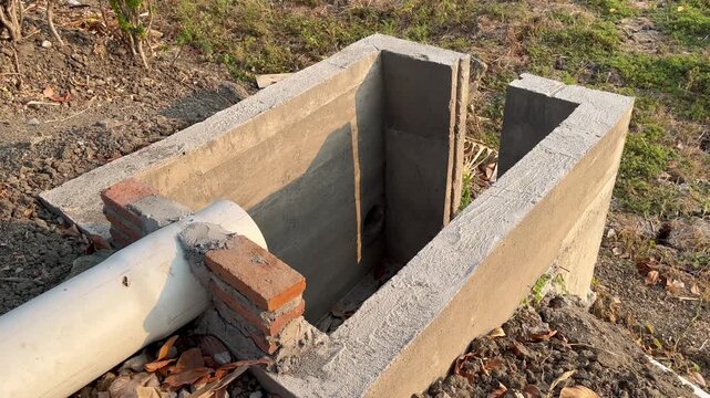 Concrete Catch Basin with Red Brick Support and PVC Drainage Pipe