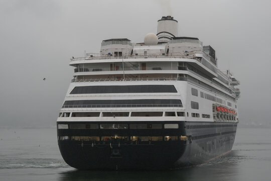 Classic luxury cruiseship cruise ship liner Zaandam Volendam arrival to Vancouver, BC after Alaska wilderness adventure Last frontier landscape nature scenery cruising with low hanging clouds misty